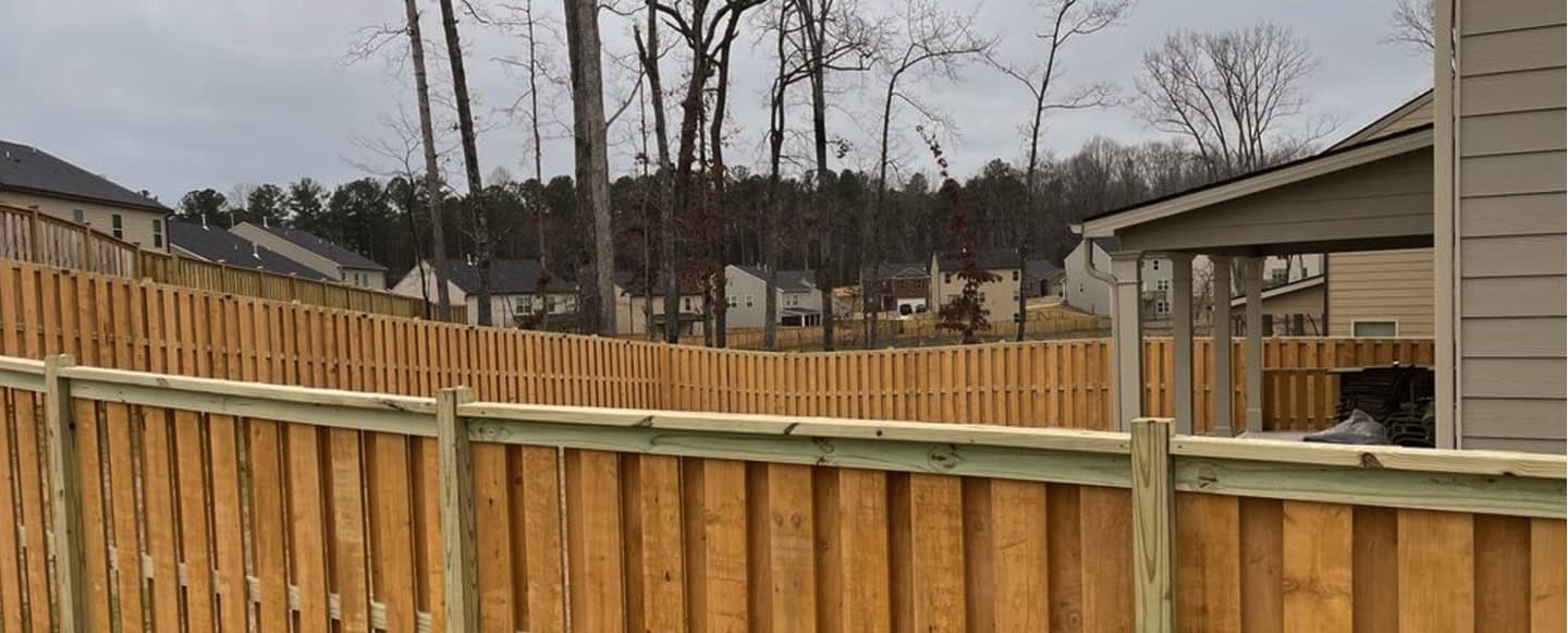 Wooden fence installation in a residential neighborhood